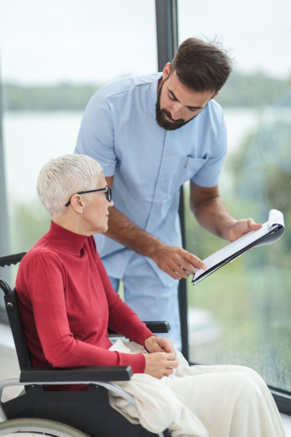 A support worker going through a written plan with a woman using a wheelchair